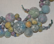 Light blue clumped-bead necklace with silk-fiber decoration