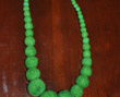 Long strand of graduated-size green felt beads