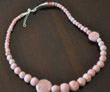 Strand of graduated-size pink felt beads with felt discs