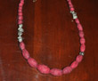 Maroon oval graduated-size felt beads with pyrite beads